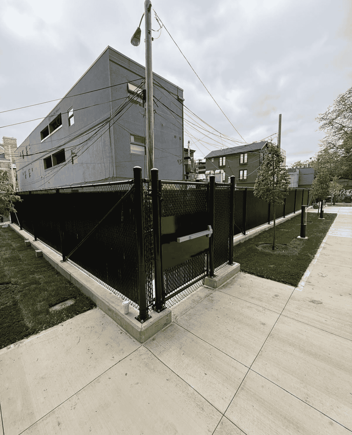 black chain link fence with privacy slats installed in Ontario, Canada